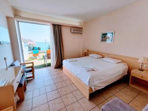 Ένα ή περισσότερα κρεβάτια σε δωμάτιο στο New Aegli Resort Hotel