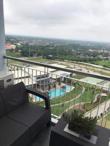a balcony with a view of a swimming pool at smdc residences tagaytay tower 1 condo unit in Tagaytay