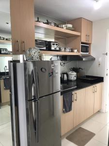 a kitchen with a stainless steel refrigerator and cabinets at smdc residences tagaytay tower 1 condo unit in Tagaytay