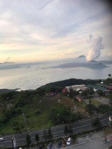 a view of the ocean with a fire in the distance at smdc residences tagaytay tower 1 condo unit in Tagaytay