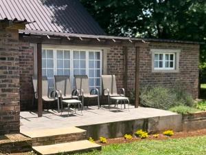 a group of chairs sitting on a patio at LionsGate Self-Catering Accommodation in Dargle