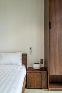 a bedroom with a bed and a nightstand next to a bed sidx sidx sidx at Stockholm Apartment in Ho Chi Minh City