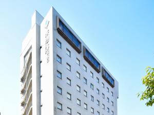 a white building with windows on the side of it at HOTEL MYSTAYS Kanazawa Katamachi in Kanazawa