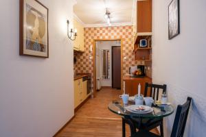 a small kitchen with a table in a room at Romantic Studio secret garden in Budapest +28 photos