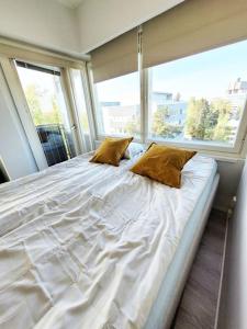 a large bed in a room with a large window at TapiolaSky: airy, bright, great bed and spacious - close to Aalto campus and Tapiola center in Espoo
