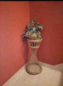 a vase with flowers in it sitting in a corner at Zdenka Studio Split in Split