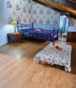 a bedroom with two beds and a table with fruit on it at Leon Rooms in Tbilisi City