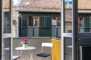 a balcony with a table and chairs on a building at Home sweet Home in Budapest