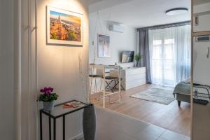 a living room with a table and a desk at Home sweet Home in Budapest