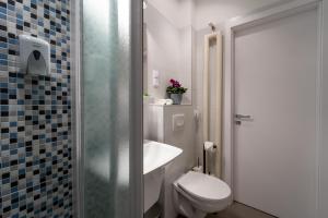 a bathroom with a toilet and a sink and a shower at Home sweet Home in Budapest +23 photos