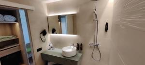 a bathroom with a shower and a sink and a mirror at Ohtels Carabela in Matalascañas