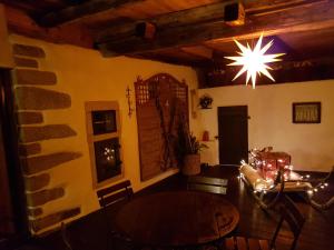 a dining room with a table and a chandelier at Ferienhaus Rachelblick in Kirchberg