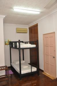 two bunk beds in a room with a door at 3 Little Birds Home, 100meter to JonkerWalk in Malacca