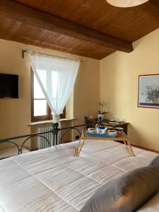 a bedroom with a bed with a table on it at La Busca Country House in Monte Benedetto