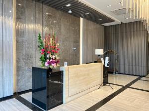 a lobby with a reception desk with a bouquet of flowers at Uptown Parksuites II in Manila