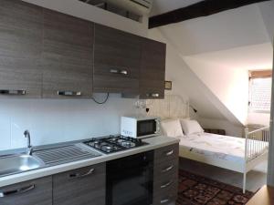 a kitchen with a stove top oven next to a bed at Residenze Torinesi in Turin