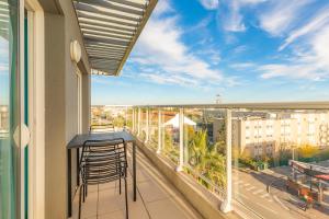 a balcony with a bar and a view of a city at Appart'City Confort Montpellier Ovalie II in Montpellier