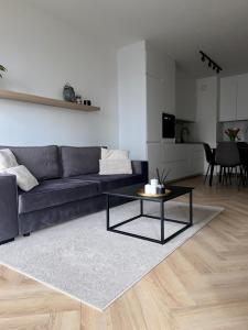 a living room with a couch and a table at Casa Baltico Letnica in Gdańsk