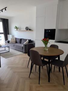 a living room with a table and chairs and a couch at Casa Baltico Letnica in Gdańsk