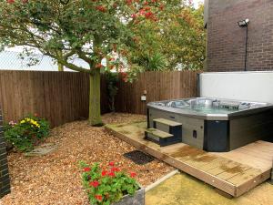 a hot tub sitting on a wooden deck next to a tree at The Tower in Boston