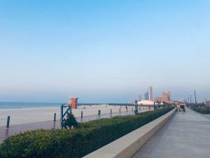 a sidewalk next to a beach next to a beach at Private Cottage in Sharjah