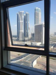 a view from a window of a city with tall buildings at Large cozy Studio(Hamilton Residency) in Dubai