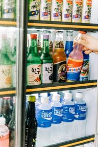 a refrigerator filled with lots of different types of drinks at Cozy Dome Glamping w/ Private Hot Spring (2pax) in Lubo