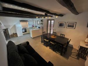 a living room and kitchen with a table and chairs at Cal Moliner De Castelladral in Castelladral