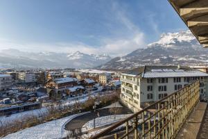 a view of a city with mountains in the background at Résidence du Parc - Happy Rentals in Saint-Gervais-les-Bains +19 photos