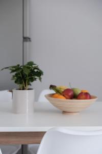 a bowl of fruit on a counter with a plant at spiti lithero in Arillas +10 photos