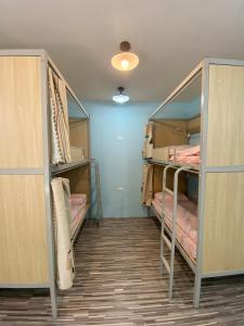 a room with three bunk beds in a room at Yo Yo Dive in Xiaoliuqiu