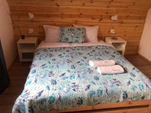 a bedroom with a bed with two towels on it at Morski Las in Ustronie Morskie