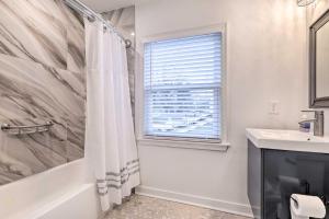 a bathroom with a shower curtain and a sink at Washington, DC, Vacation Rental By Arboretum in Washington +17 photos