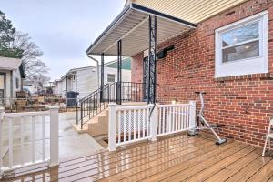 a brick house with a white fence on a deck at Washington, DC, Vacation Rental By Arboretum in Washington