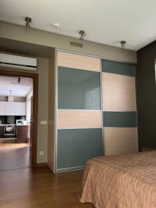 a bedroom with a large sliding glass door at Jurmala Lux Apartments - Seaside in Jūrmala