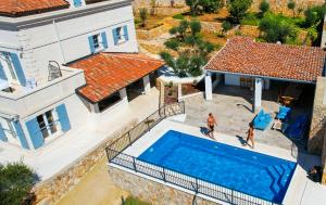 an aerial view of a house with a swimming pool at Rooms Salvia in Cres