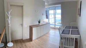 a kitchen with a desk and a hallway with a door at Apartamentai Muziejaus g. in Birštonas