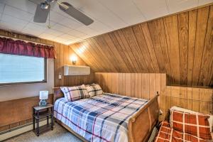 a bedroom with a bed in a wooden wall at Cozy Berlin Getaway, ATV from the Driveway in Gorham