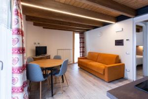 a living room with a table and a couch at Residence Villa Brioschi in Aprica