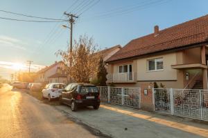 a car parked on a street next to a house at MyHome2 in Subotica