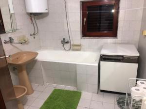 a bathroom with a white tub and a sink at Vila Bojana in Gornji Milanovac