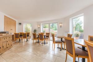 a dining room with a table and chairs at Lakeside Old Hunstanton in Hunstanton