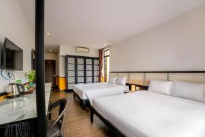 Un ou plusieurs lits dans un hébergement de l'établissement Hoi An Ivy Hotel