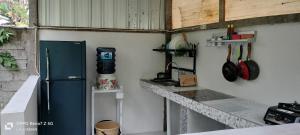 a kitchen with a blue refrigerator and a counter at The Pondok in Kuta Lombok