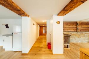 cocina con paredes blancas y techos de madera en Casa Nacla Sedrun/Surrein en Sedrun