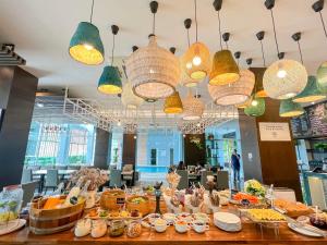 a buffet of food on a table in a restaurant at Kokotel Bangkok Dheva Thonglor in Bangkok