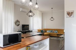 a living room with a television and a couch at House&Villas - Villa Falaride in Avola