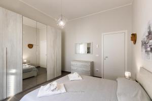 a white bedroom with a bed and a mirror at House&Villas - Villa Falaride in Avola +34 photos