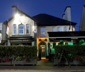a building with a man standing outside of it at The Sliding Rock Inn in Galway