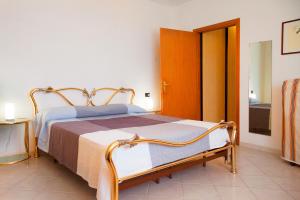 a bedroom with a bed and a door to a bathroom at Giardino La Panoramica in Rio Marina